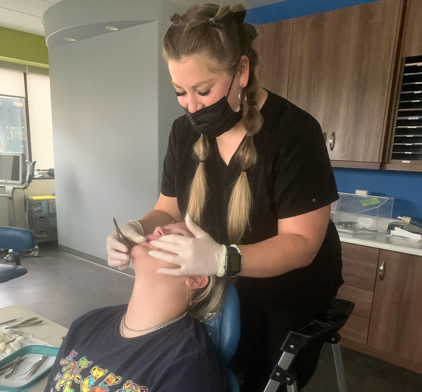 Team member examining patient's teeth